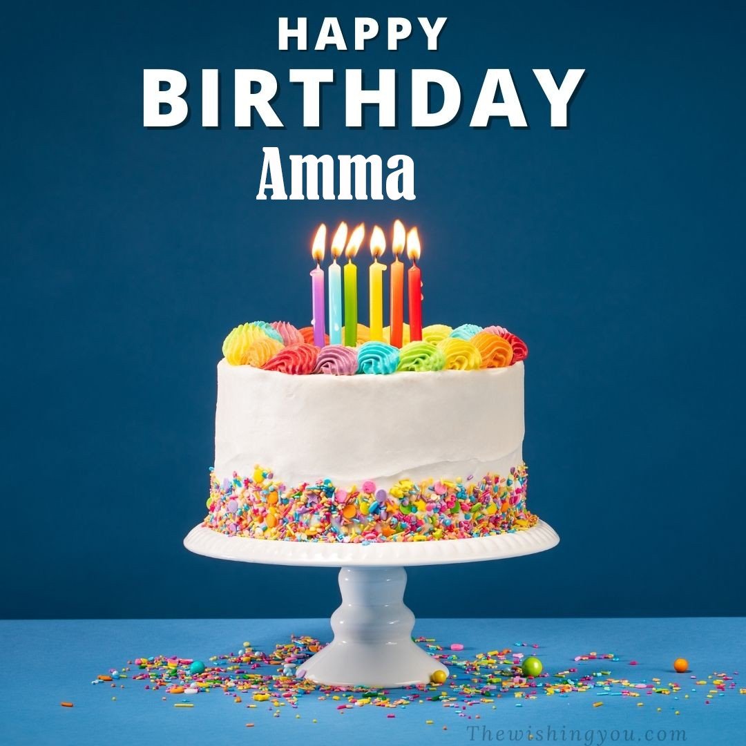 Happy birthday Amma written on image White cake keep on White stand and burning candles Sky background