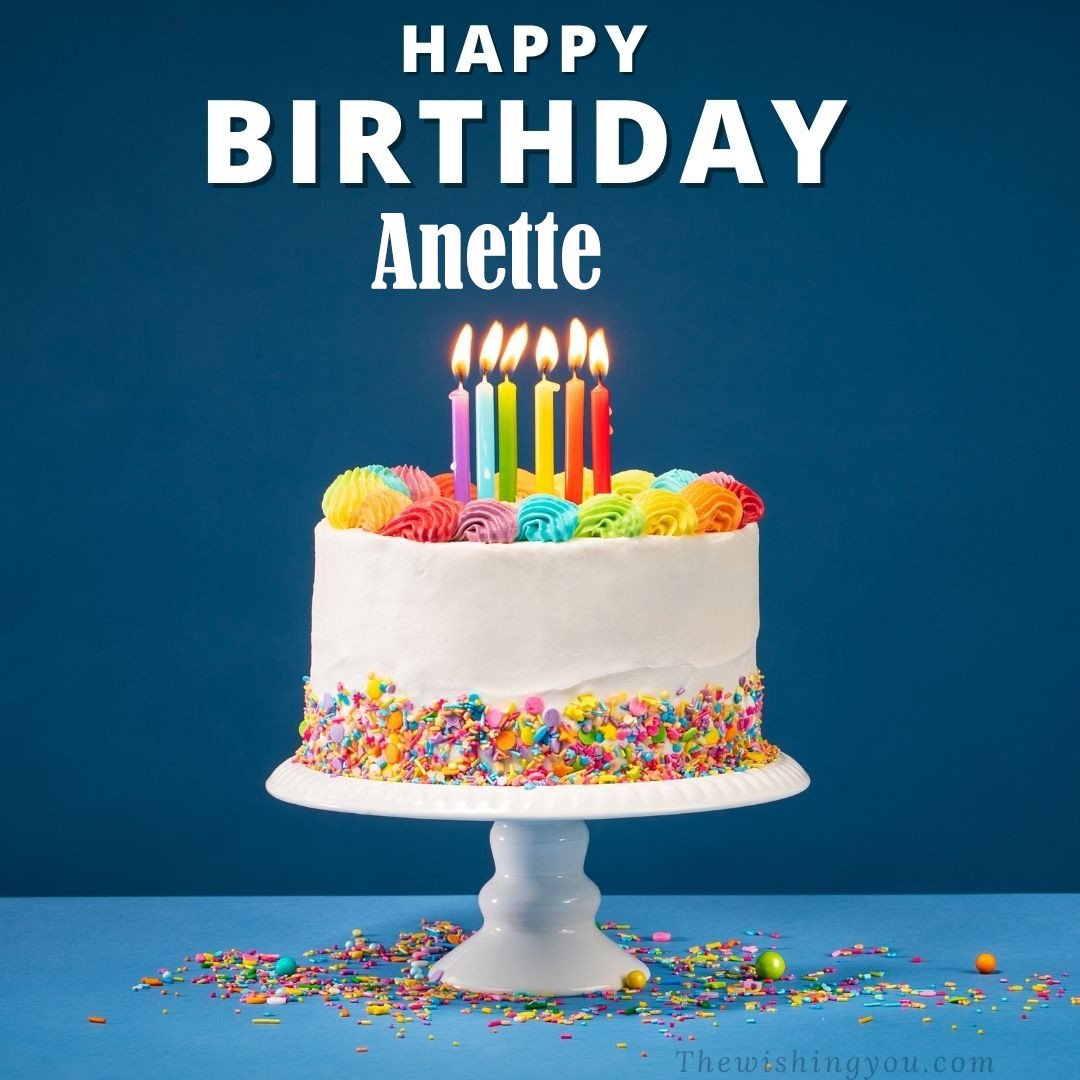Happy birthday Anette written on image White cake keep on White stand and burning candles Sky background