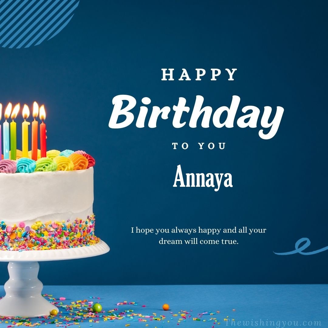Happy birthday Annaya written on image white cake and burning candle Blue Background