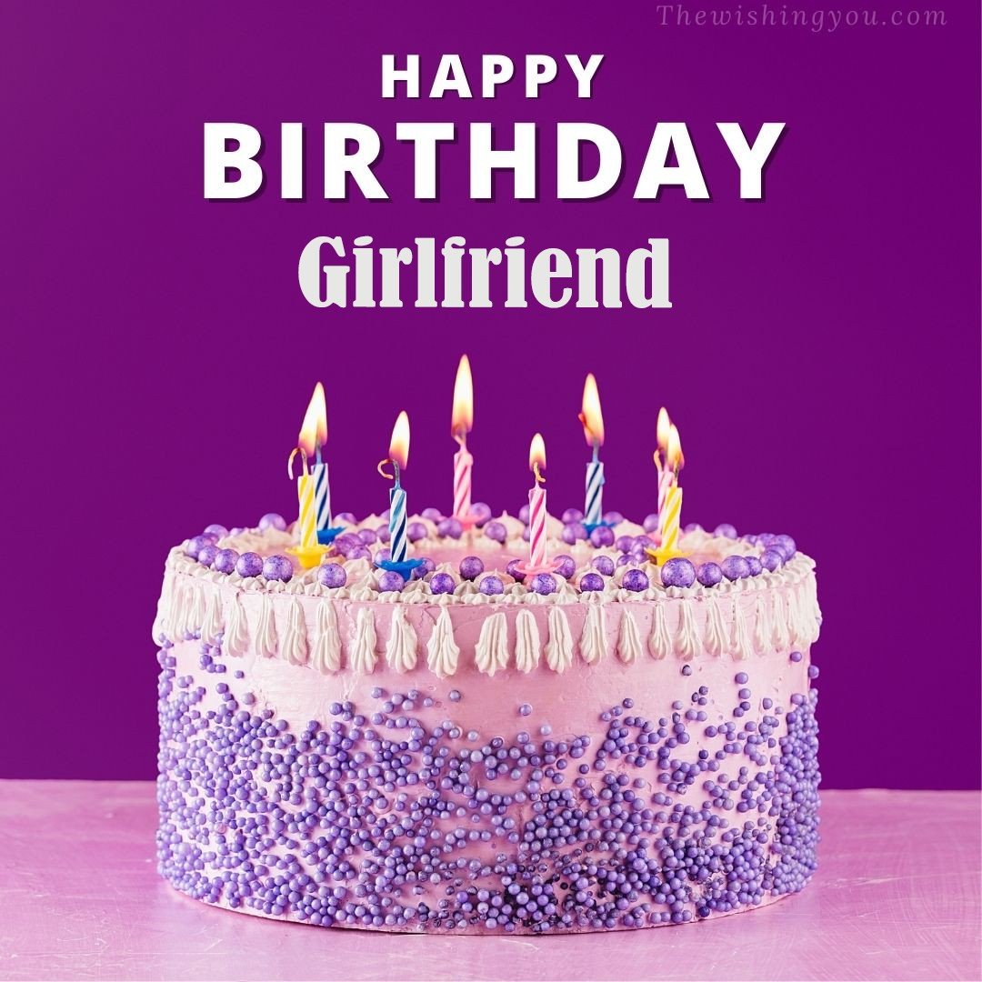 Happy birthday Girlfriend written on image White and blue cake and burning candles Violet background