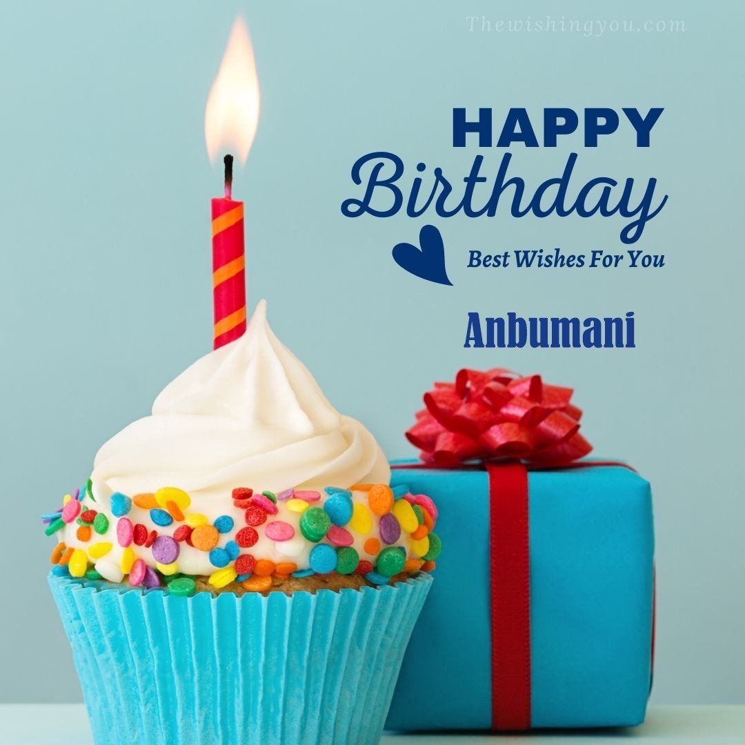 Happy Birthday Anbumani written on image Blue Cup cake and burning candle blue Gift boxes with red ribon