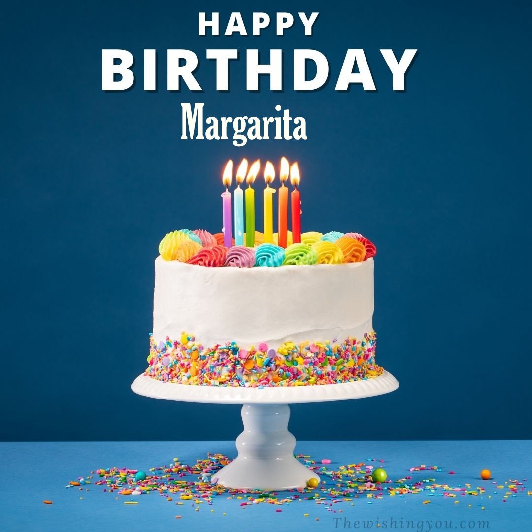 Happy birthday Margarita written on image White cake keep on White stand and burning candles Sky background