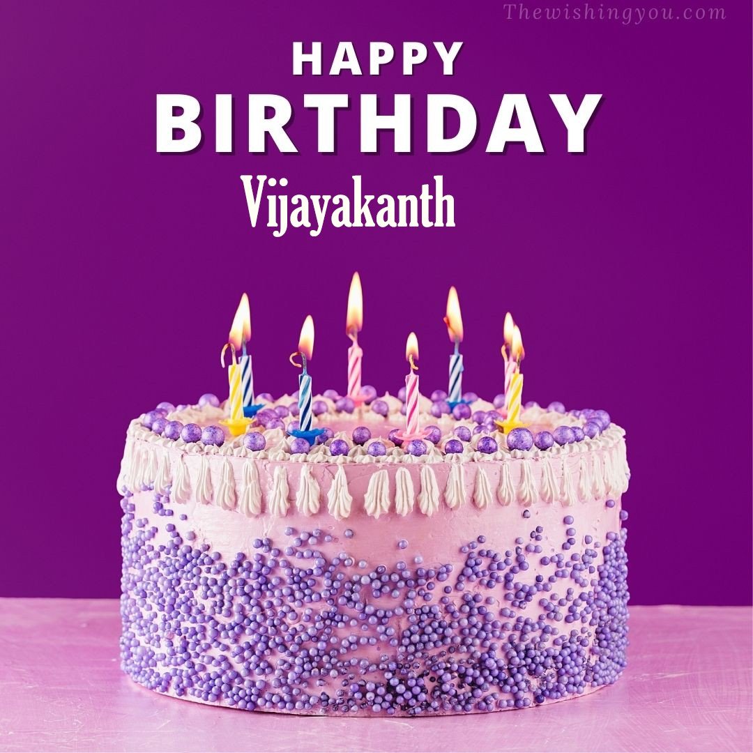 Happy birthday Vijayakanth written on image White and blue cake and burning candles Violet background