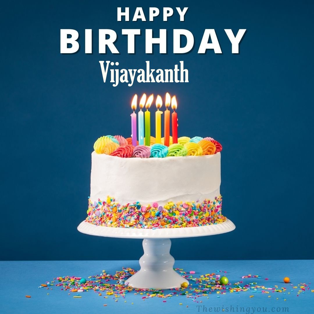 Happy birthday Vijayakanth written on image White cake keep on White stand and burning candles Sky background