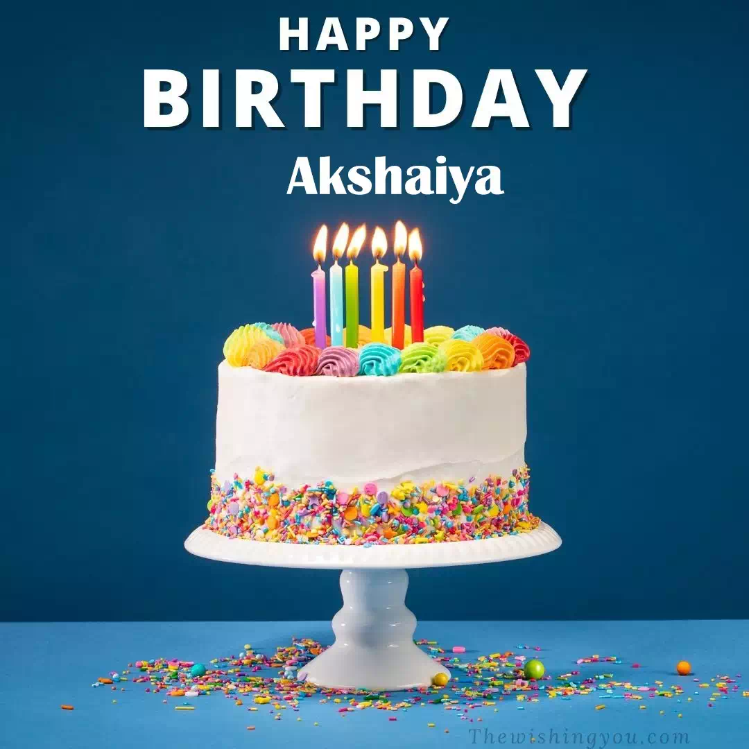 Happy Birthday Akshaiya written on image, White cake keep on White stand and burning candles Sky background