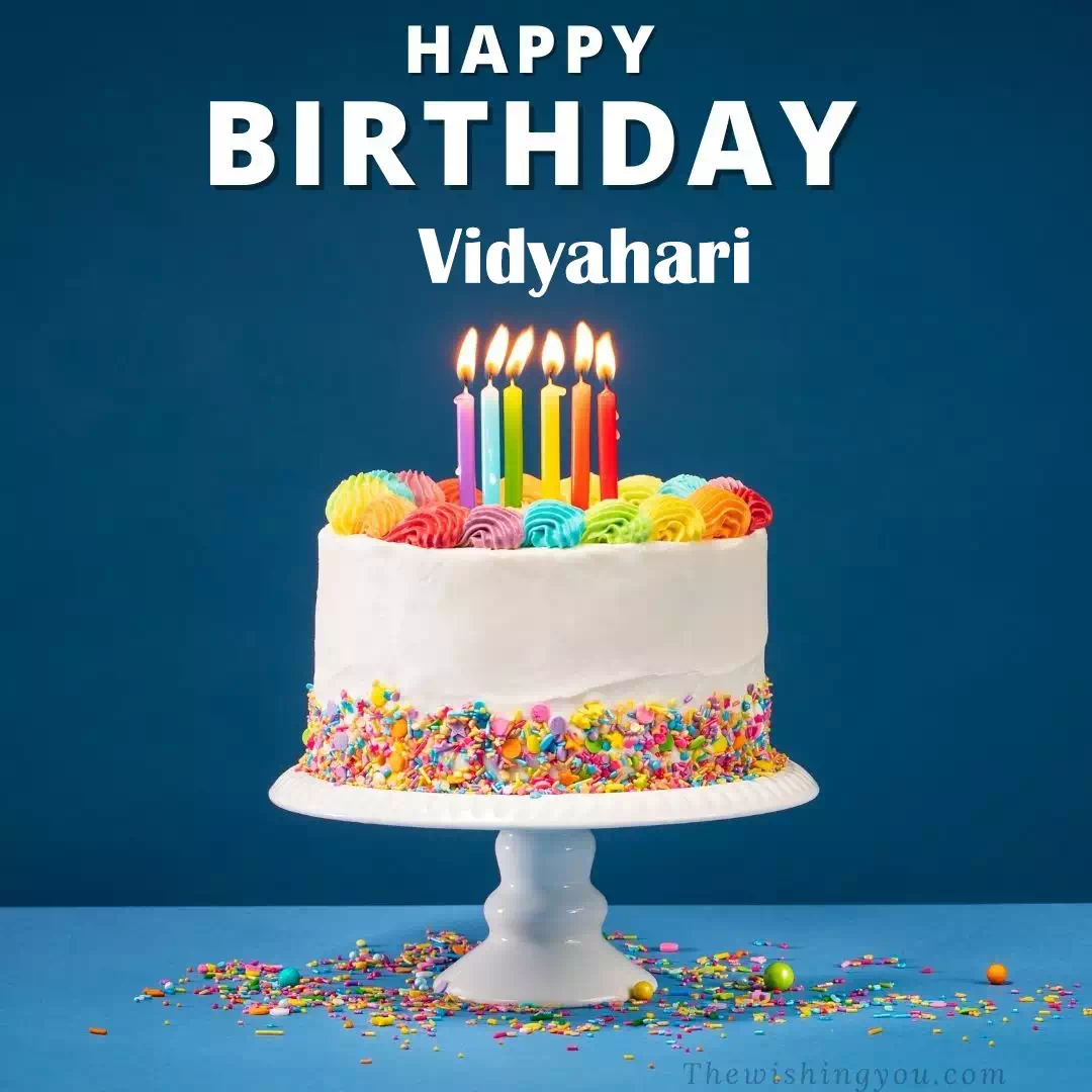 Happy Birthday Vidyahari written on image, White cake keep on White stand and burning candles Sky background